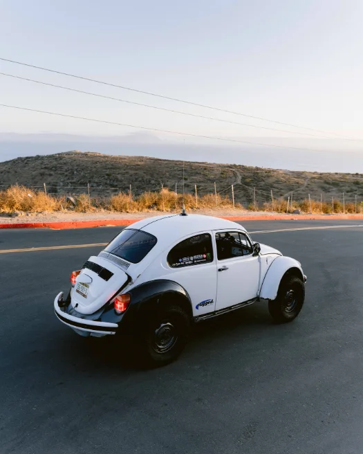 White Baja bug on a ridge road