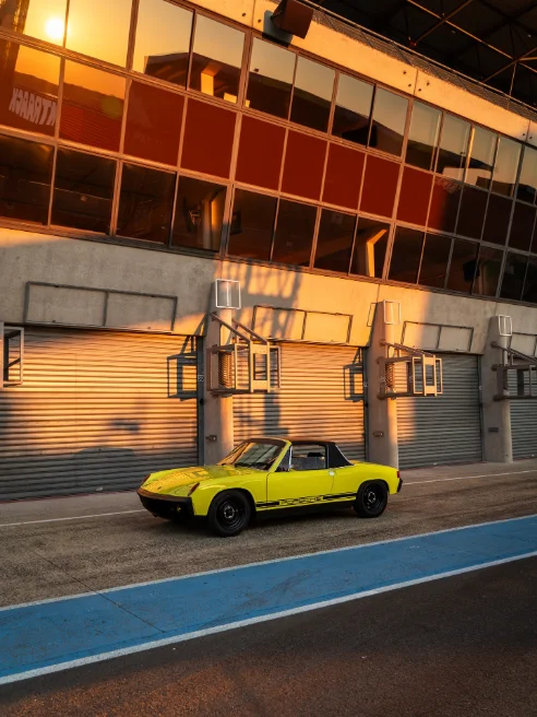 Yellow Porsche 914 in the pit lane
